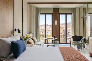 a bedroom with a bed and a couch