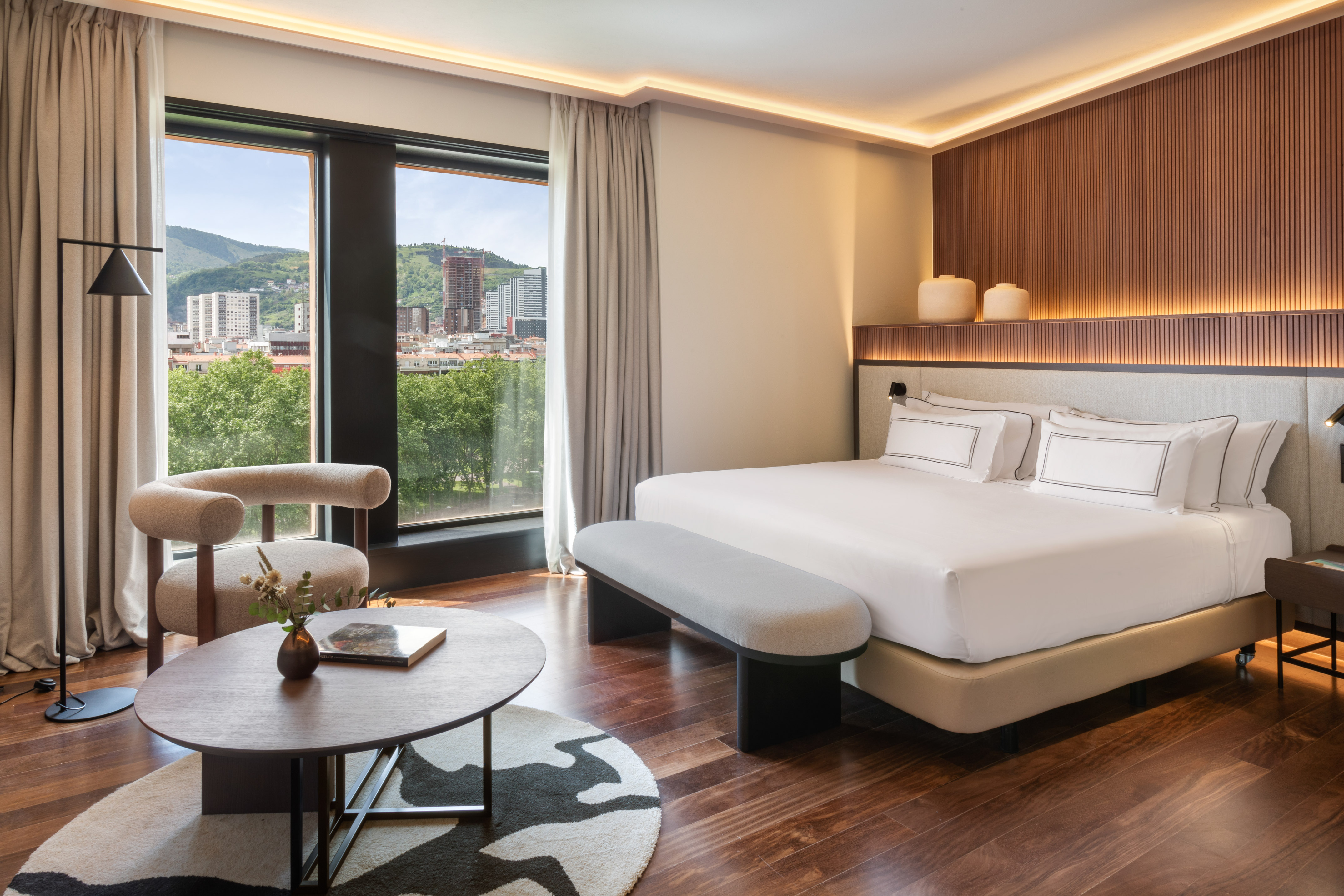 a room with a bed and a table and chairs