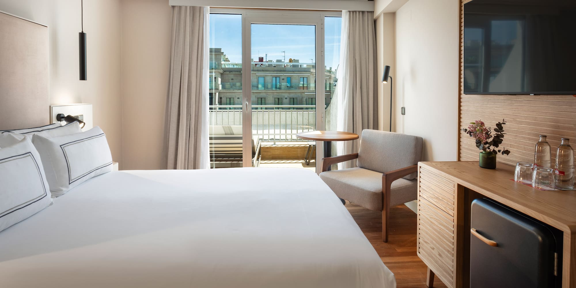 a bedroom with a bed and a television