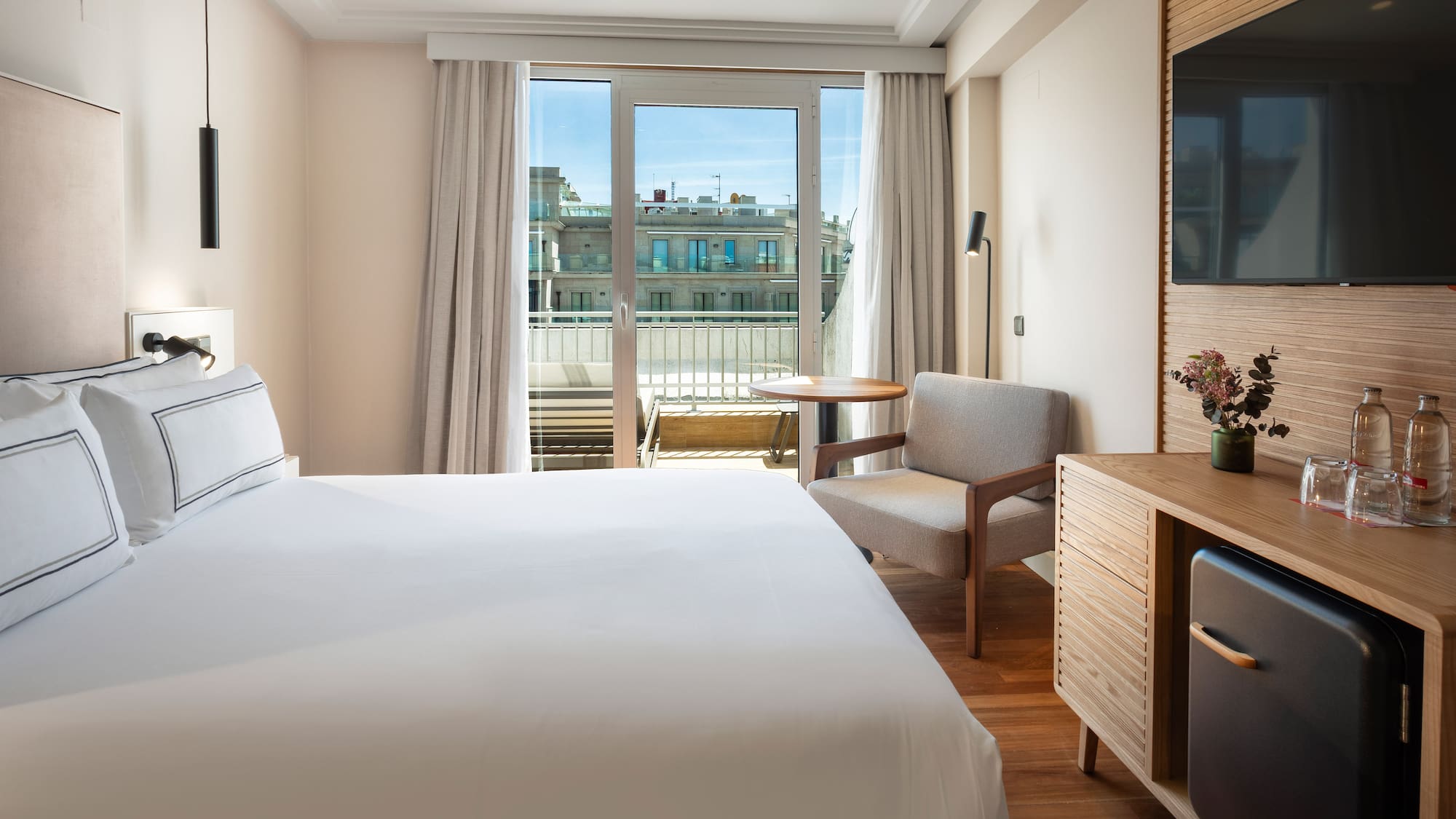 a bedroom with a bed and a television