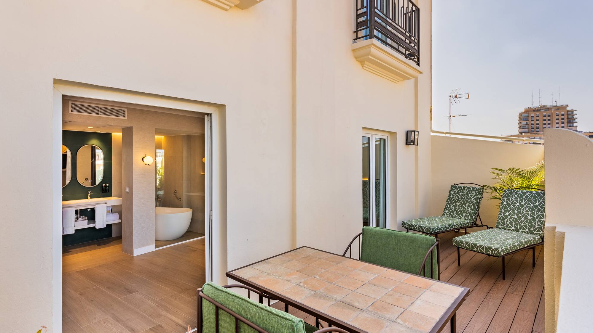 a patio with chairs and a bathtub