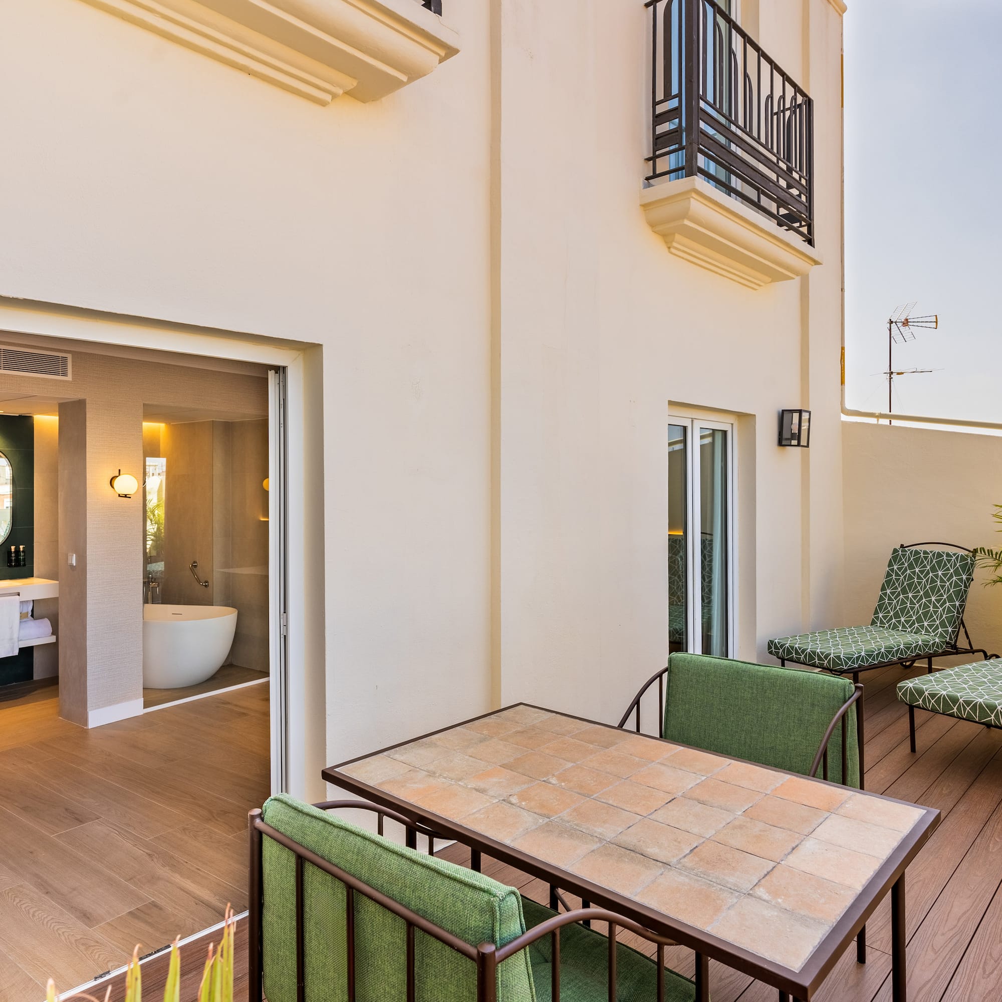 a patio with chairs and a bathtub