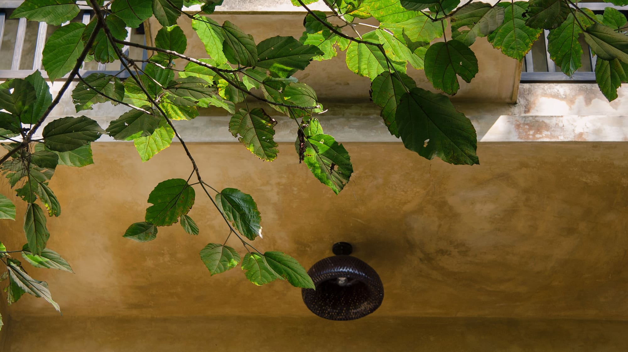 a balcony with a light fixture and a railing