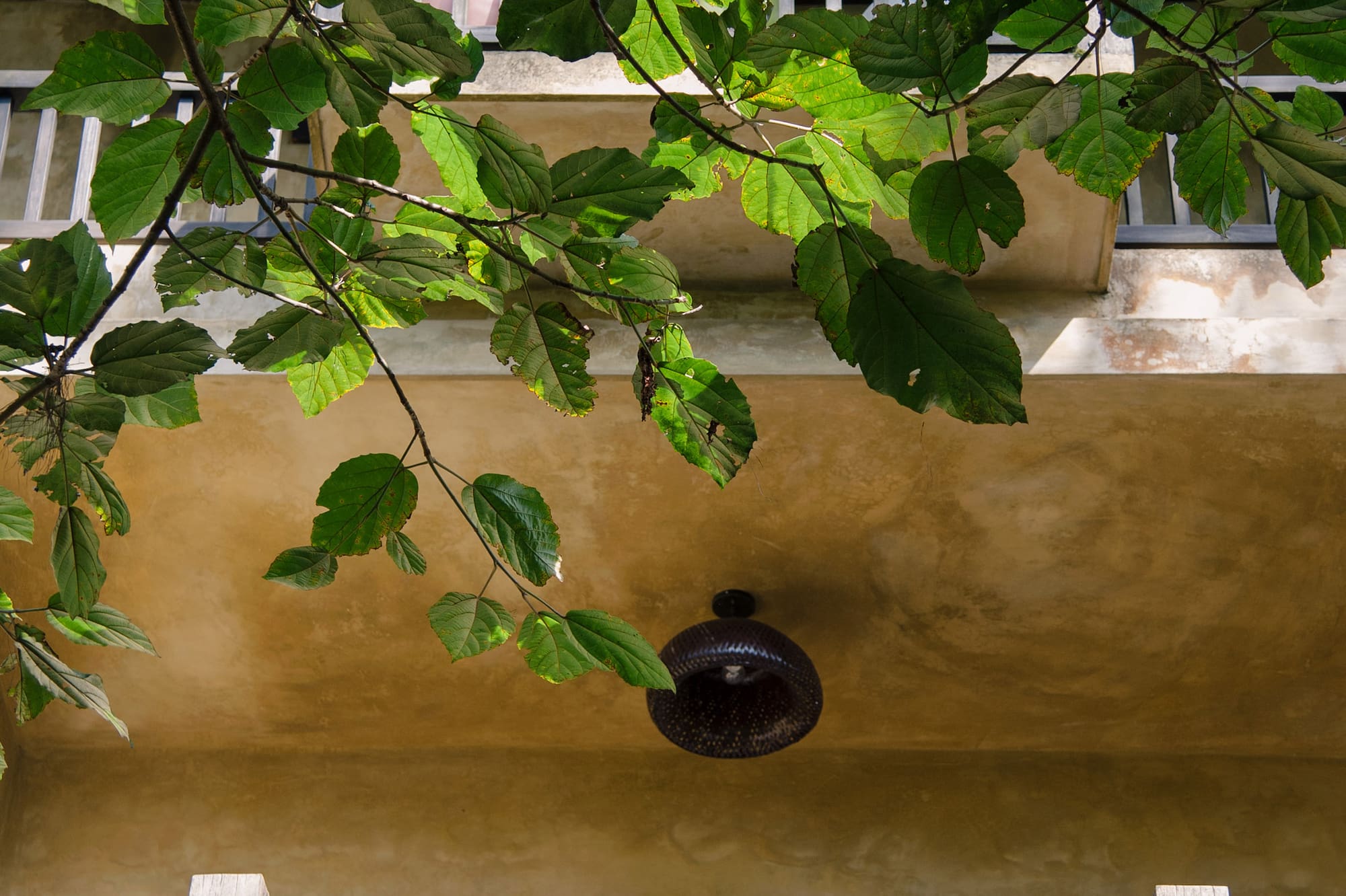 a balcony with a light fixture and a railing