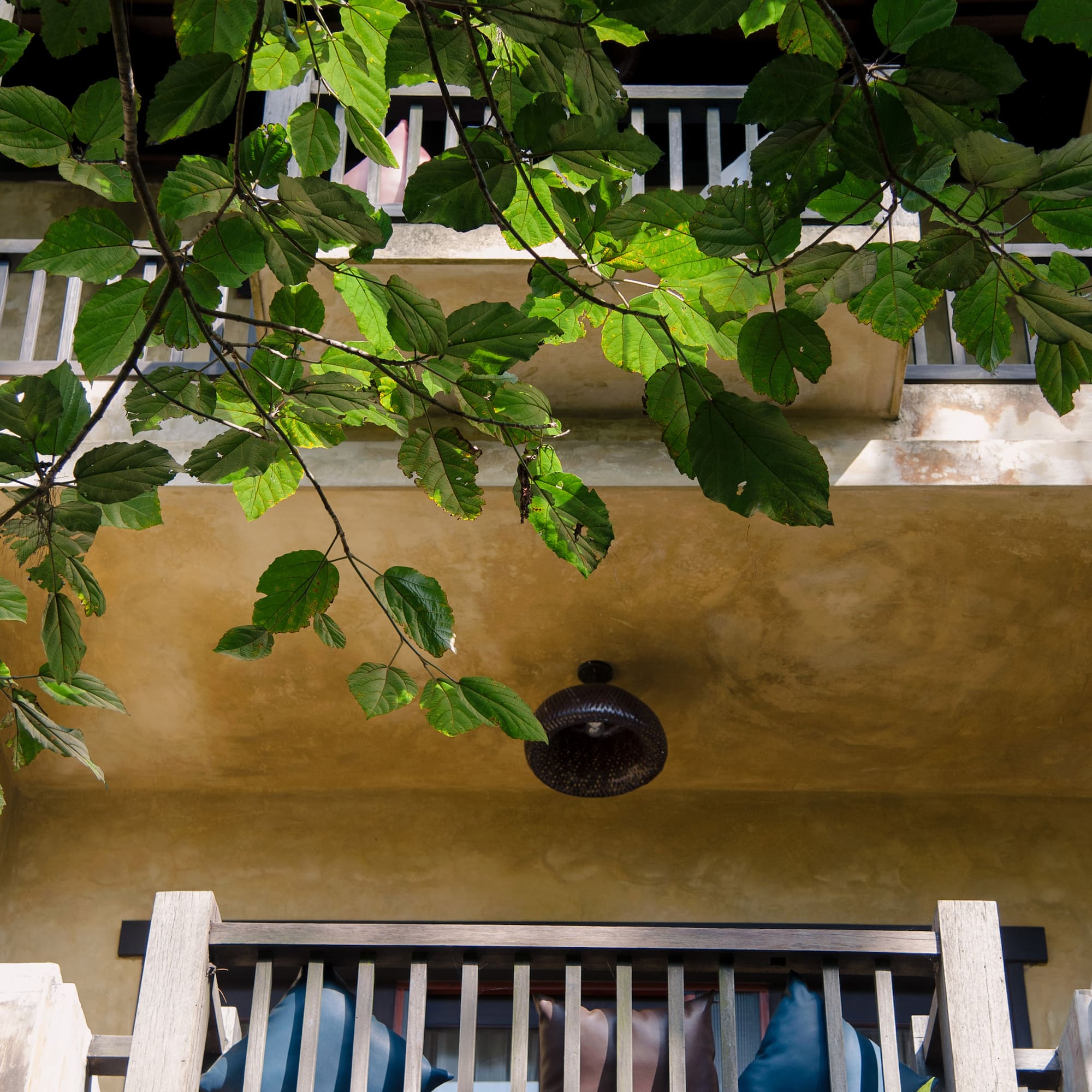 a balcony with a light fixture and a railing