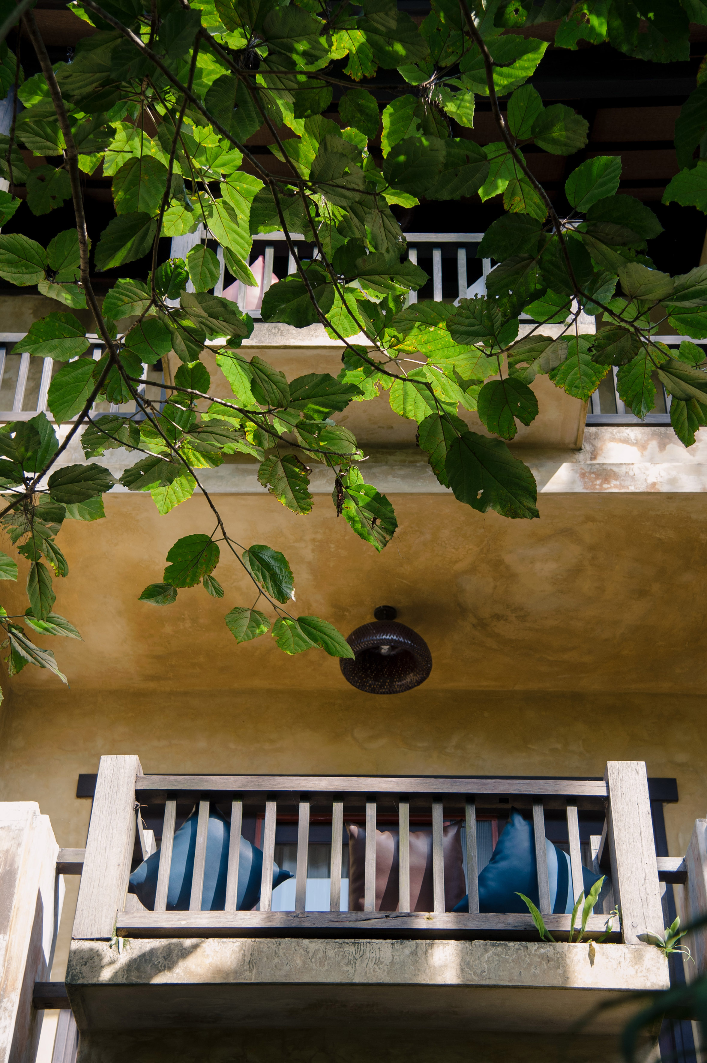a balcony with a light fixture and a railing