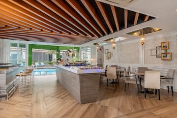 a room with a pool and a bar