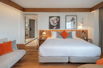 a bedroom with a bed and a couch