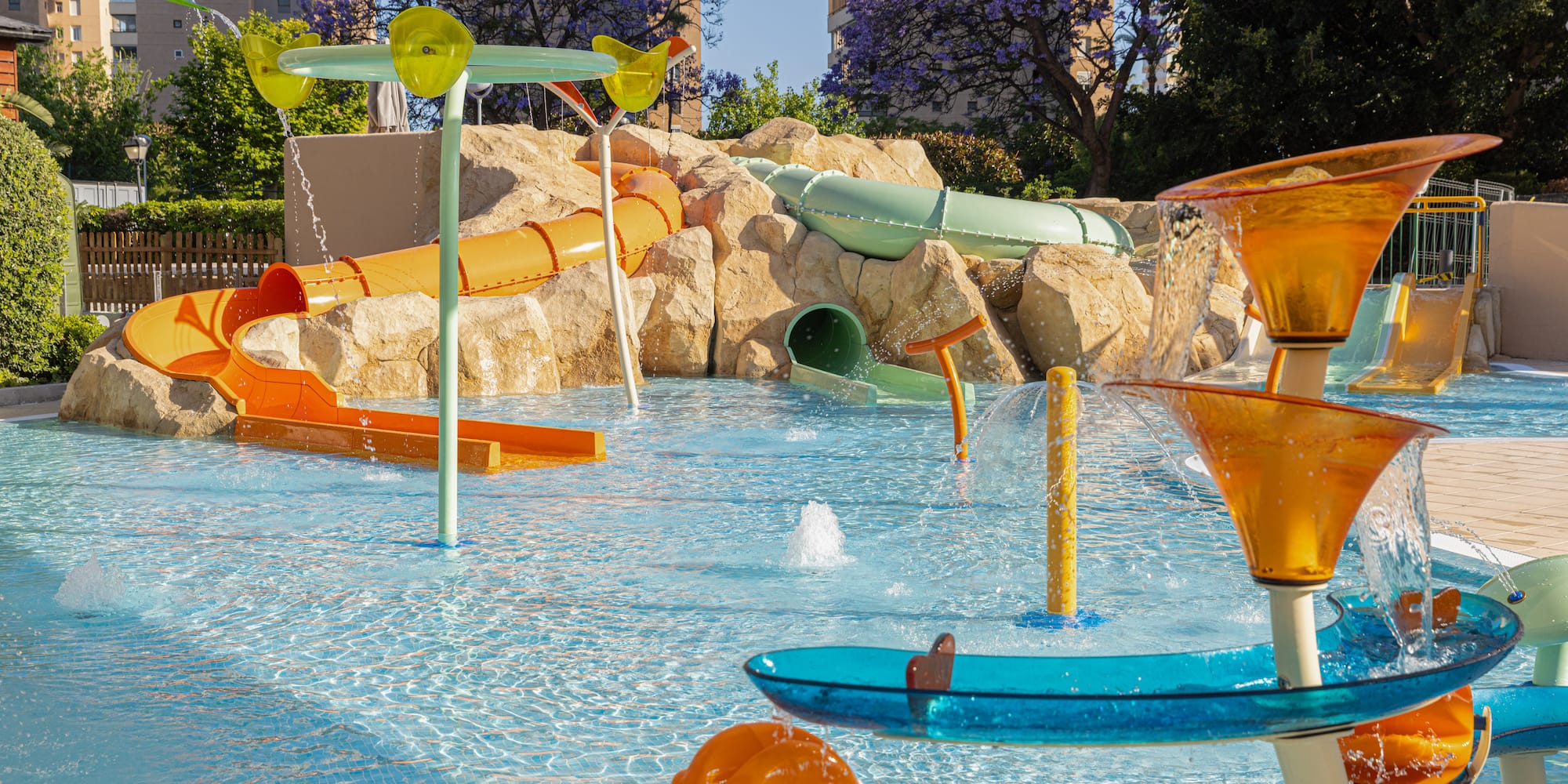 Family water park with colorful slides, splash pad, and water play features.