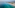 a beach with a body of water and a city