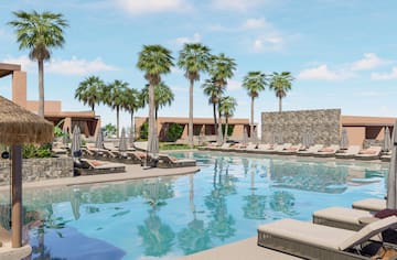 a pool with lounge chairs and palm trees