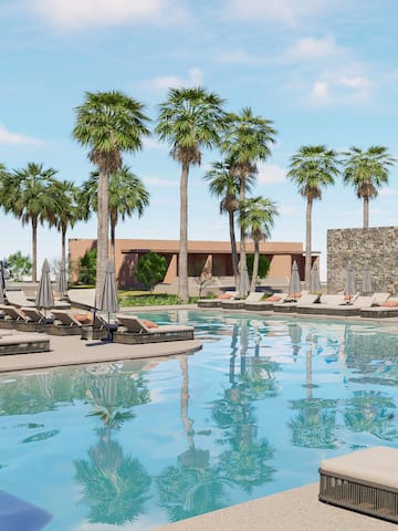 a pool with lounge chairs and palm trees