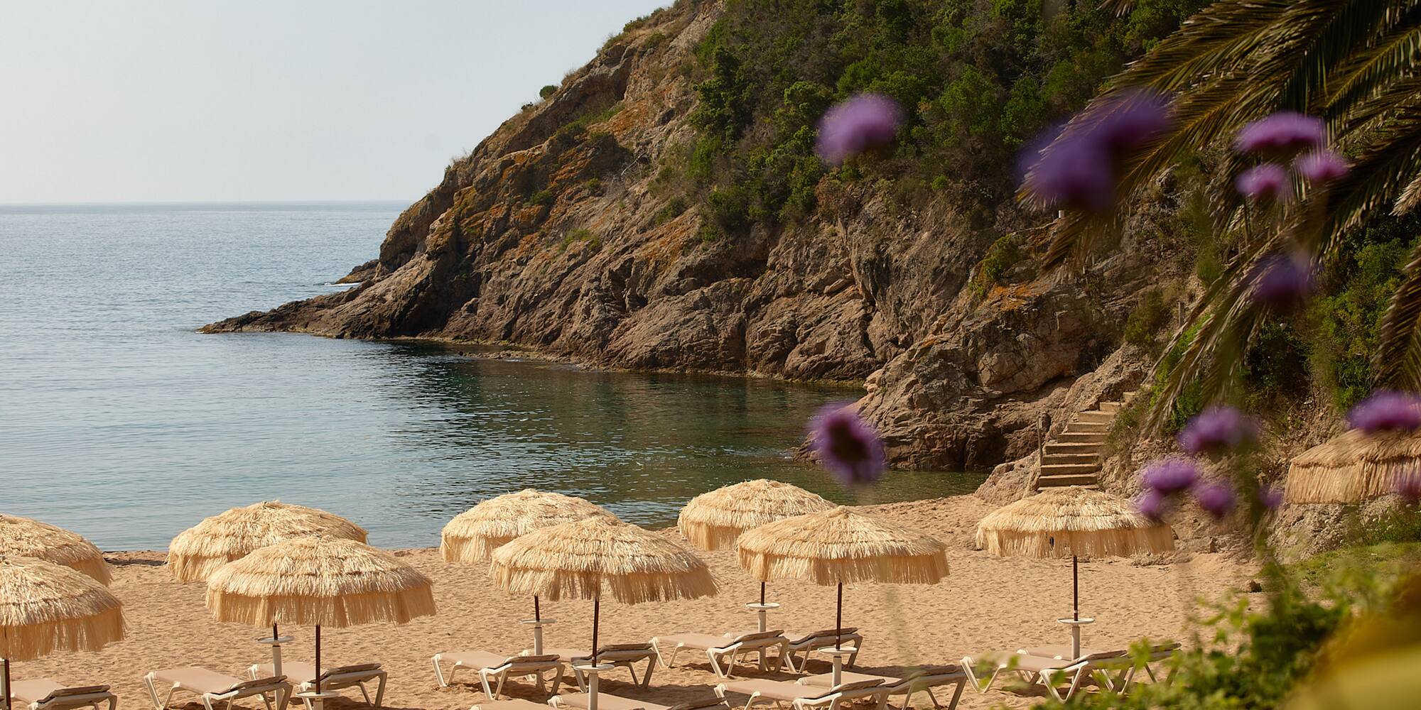 a beach with chairs and umbrellas