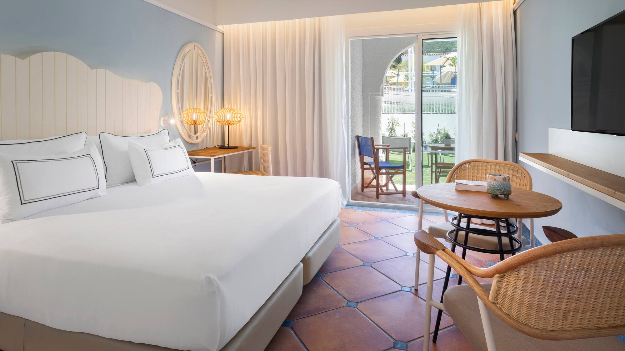 a room with a bed and chairs