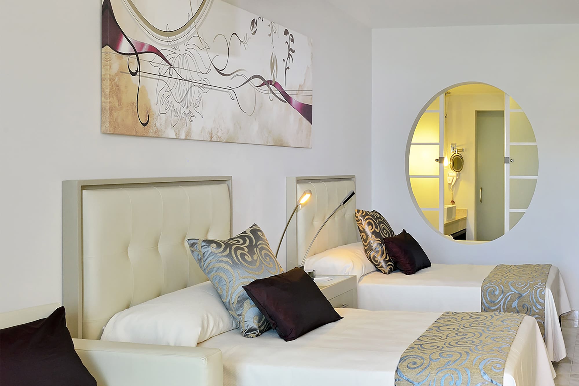 a room with two beds and a mirror