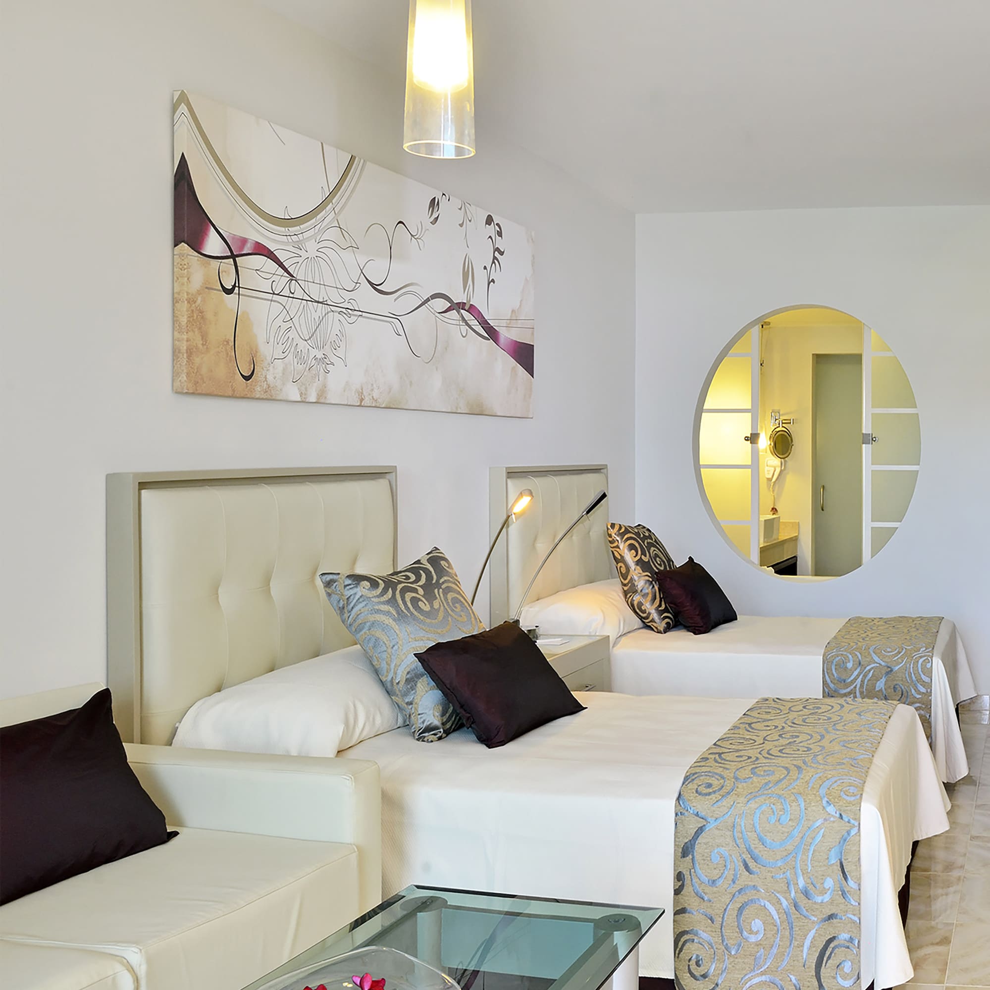 a room with two beds and a mirror