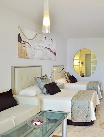 a room with two beds and a mirror