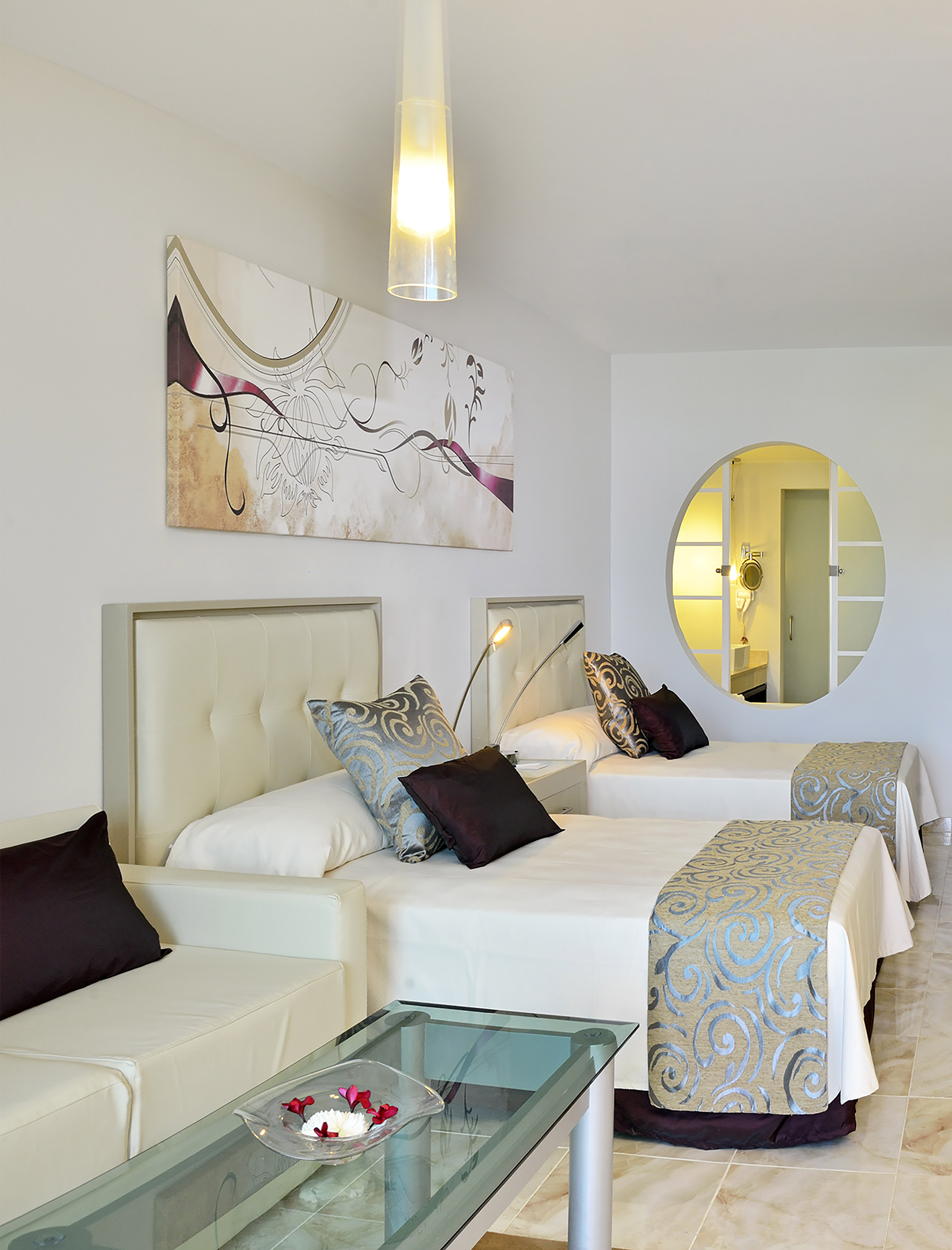 a room with two beds and a mirror