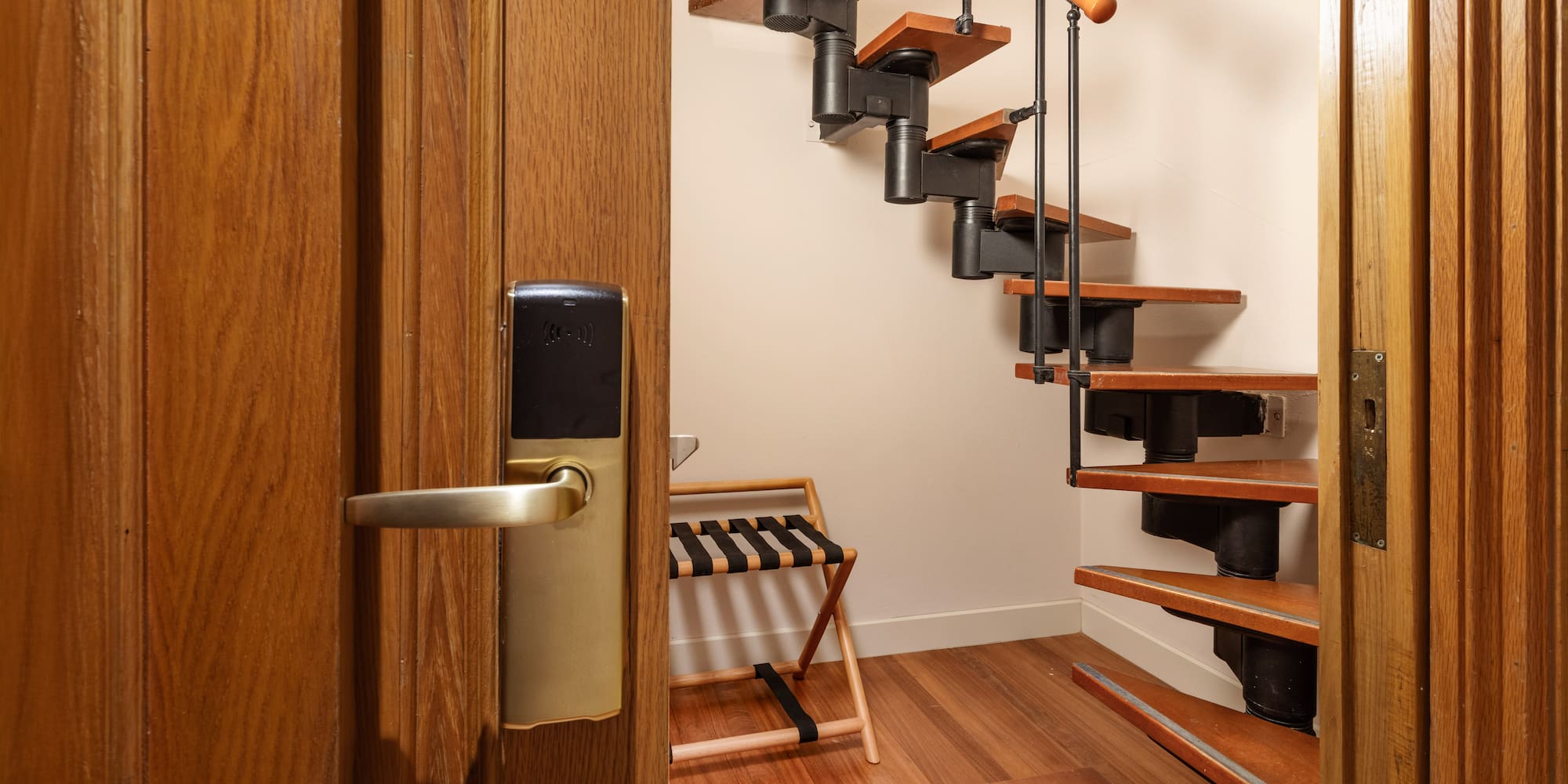 a wooden staircase with a metal railing