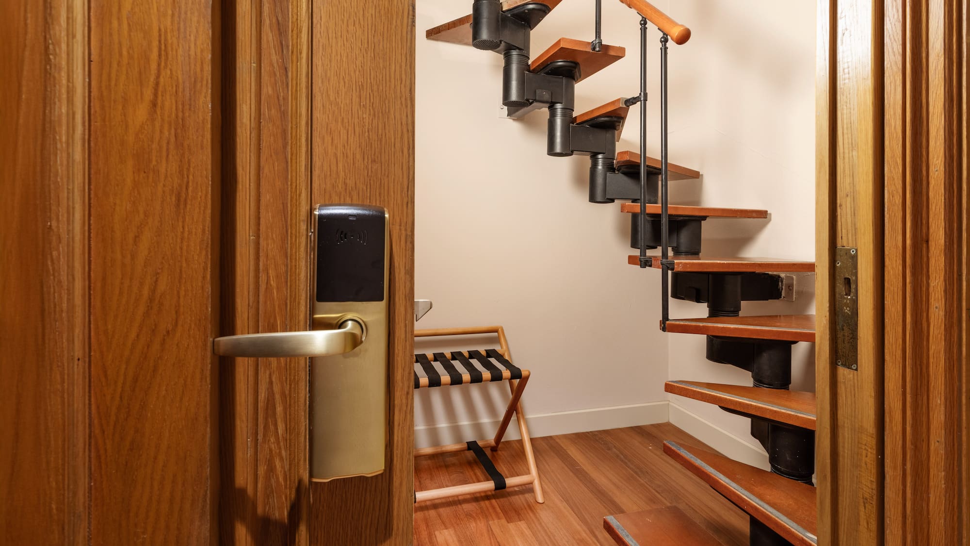 a wooden staircase with a metal railing