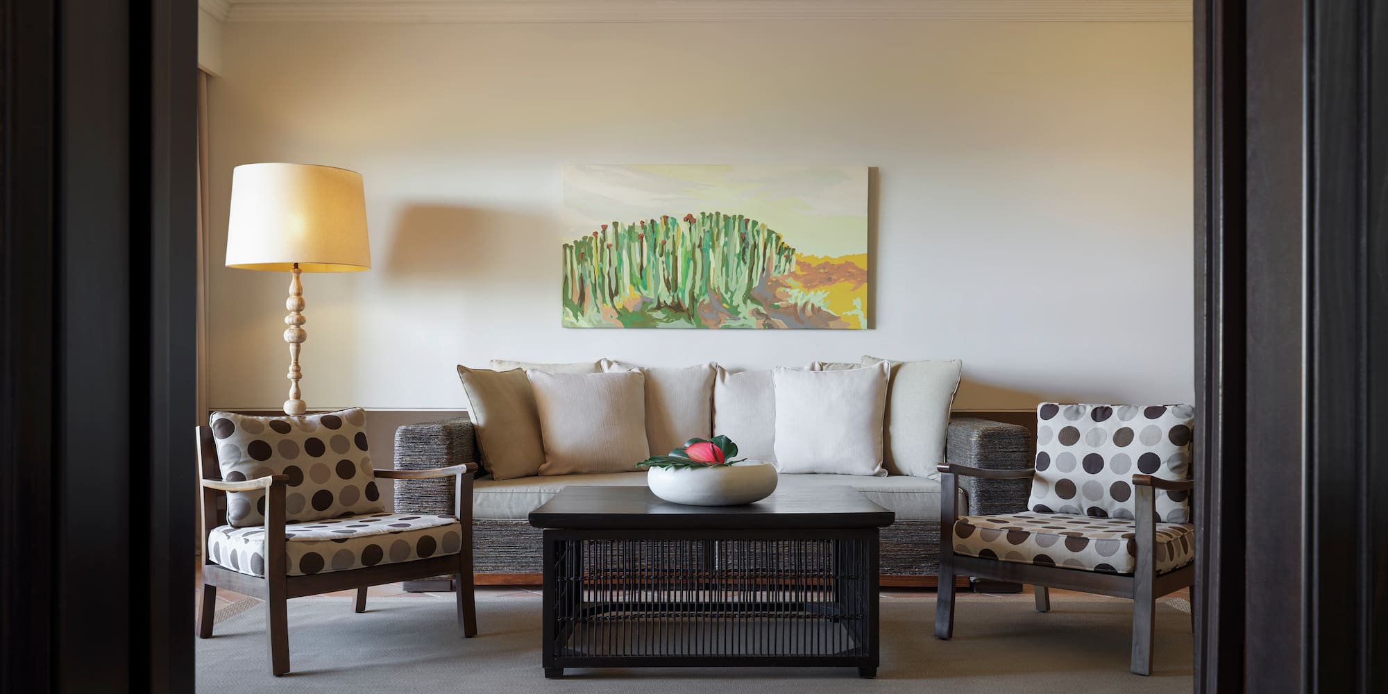 a living room with a couch and a lamp