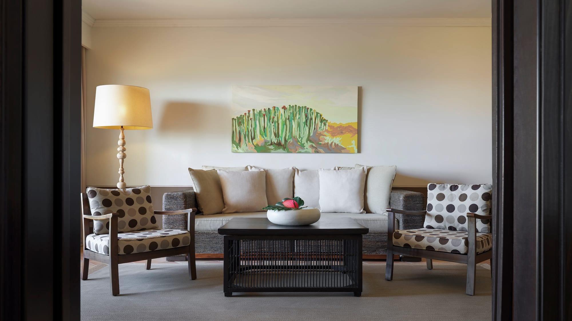 a living room with a couch and a lamp