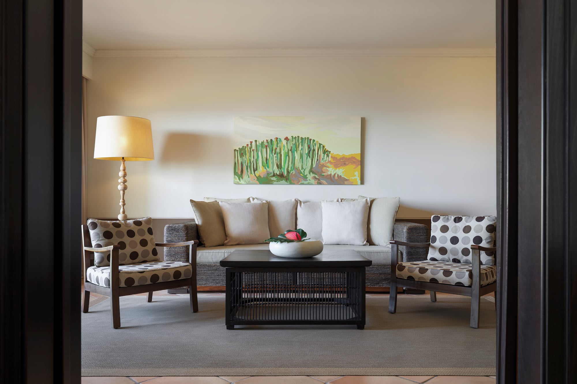 a living room with a couch and a lamp