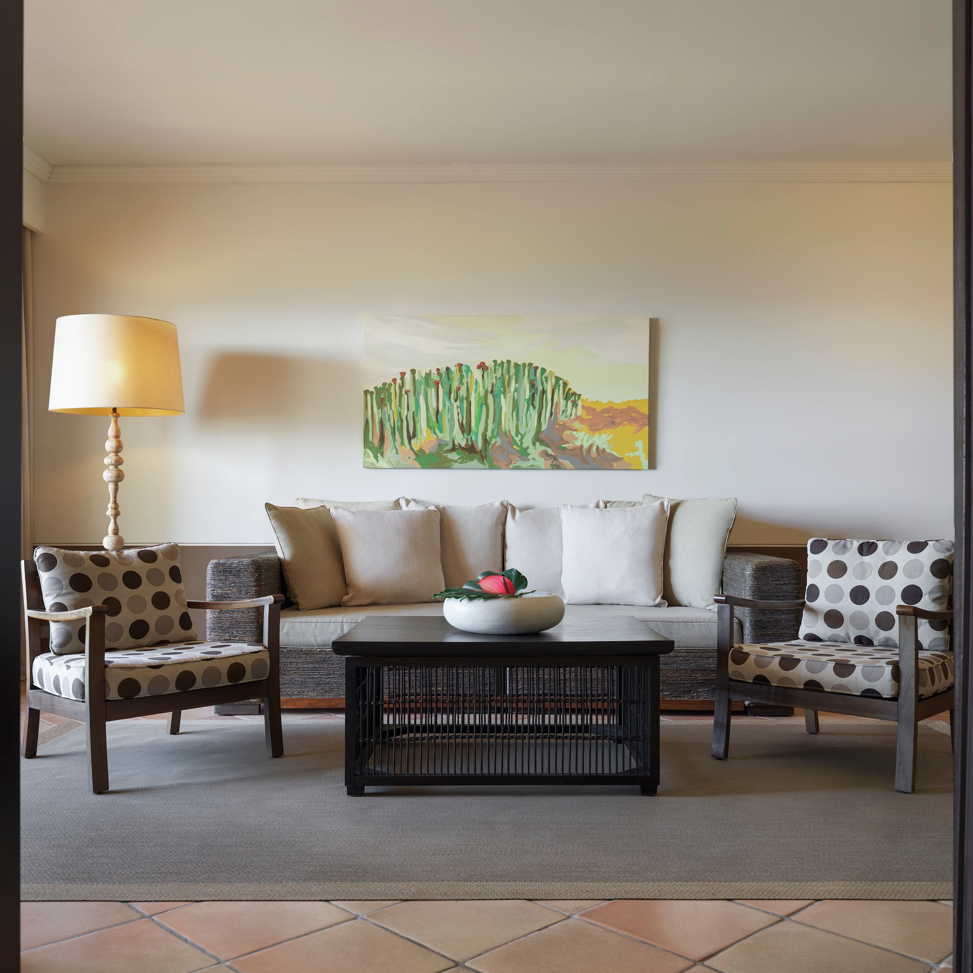 a living room with a couch and a lamp