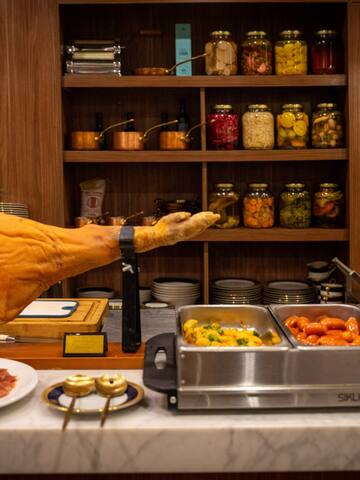a leg of a ham on a counter with food on it
