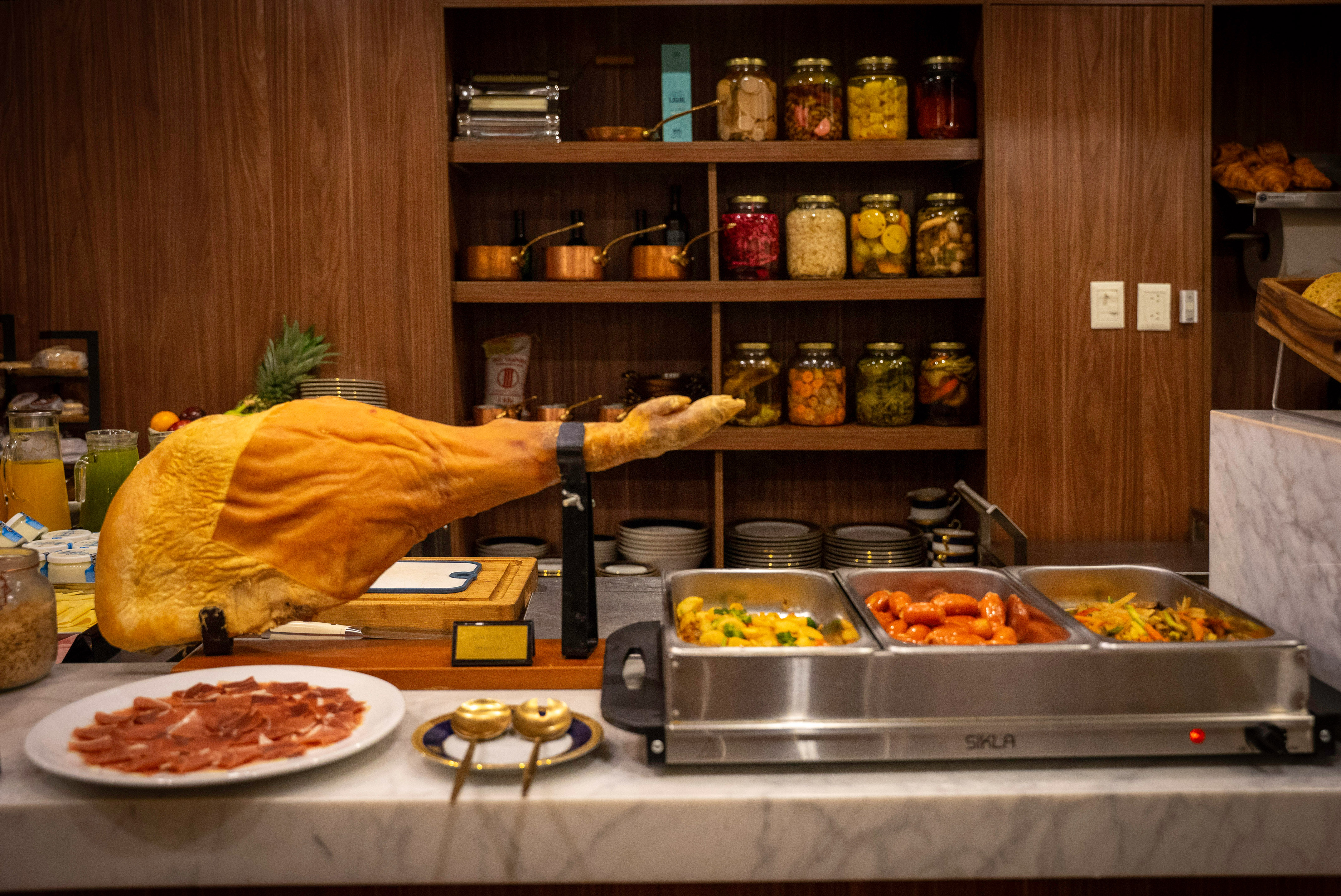a leg of a ham on a counter with food on it