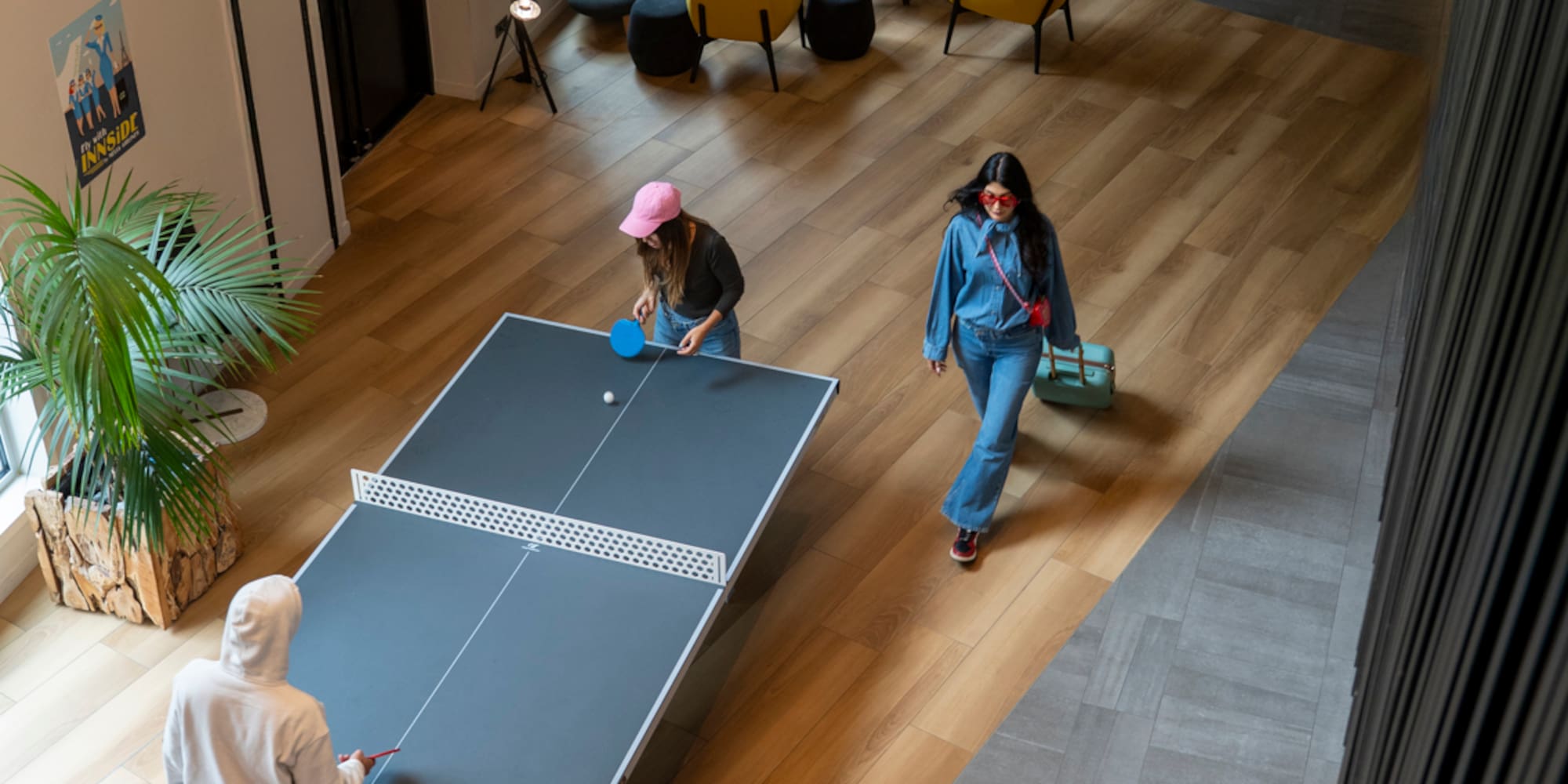 people playing ping pong in a room
