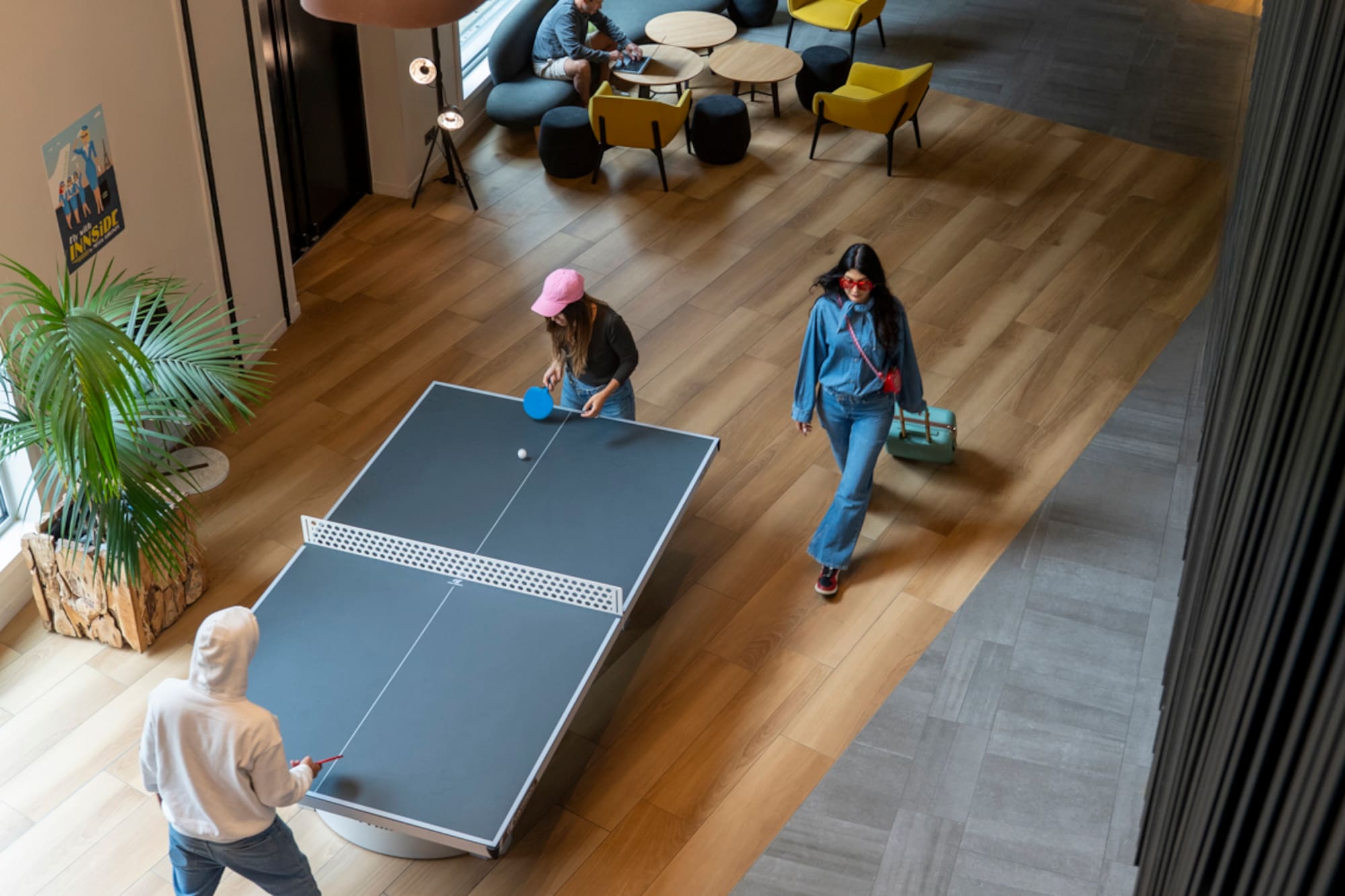 people playing ping pong in a room