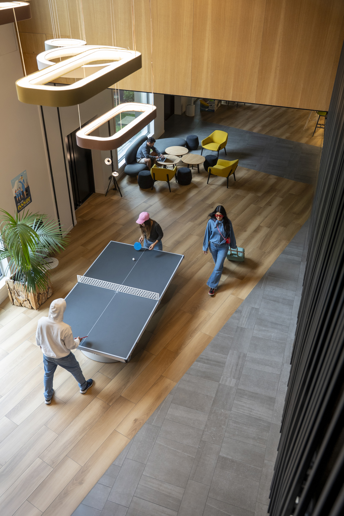 Coworking space with people playing table tennis and working.