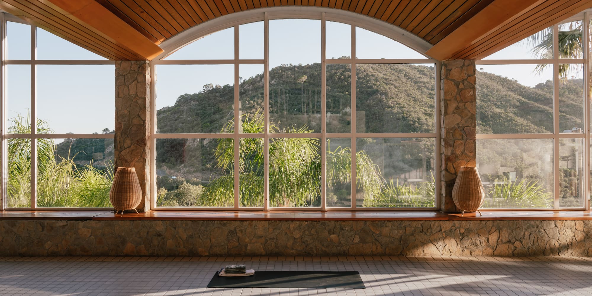 a room with a large window and a view of mountains