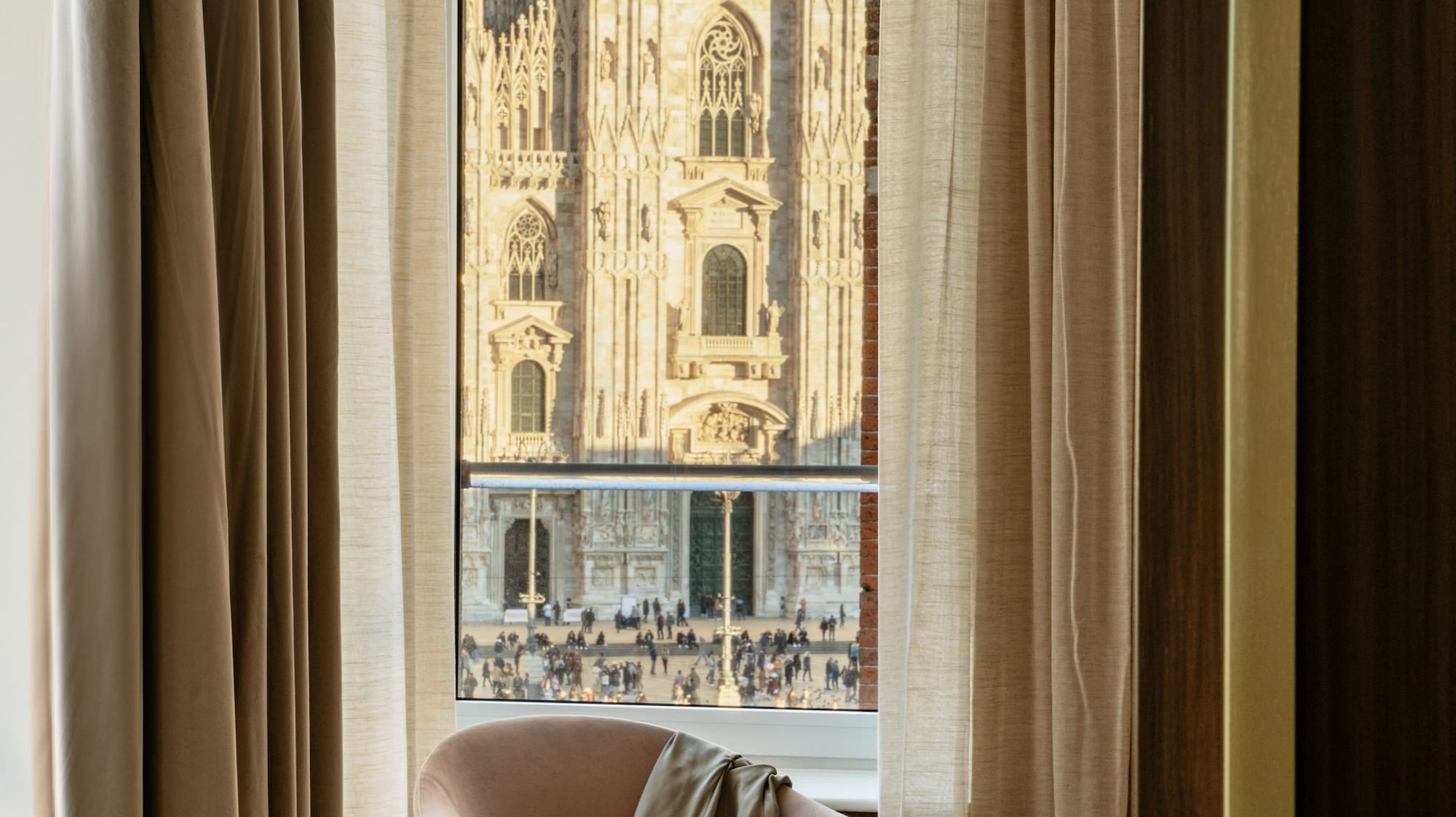 a chair in front of a window with a large building in the background