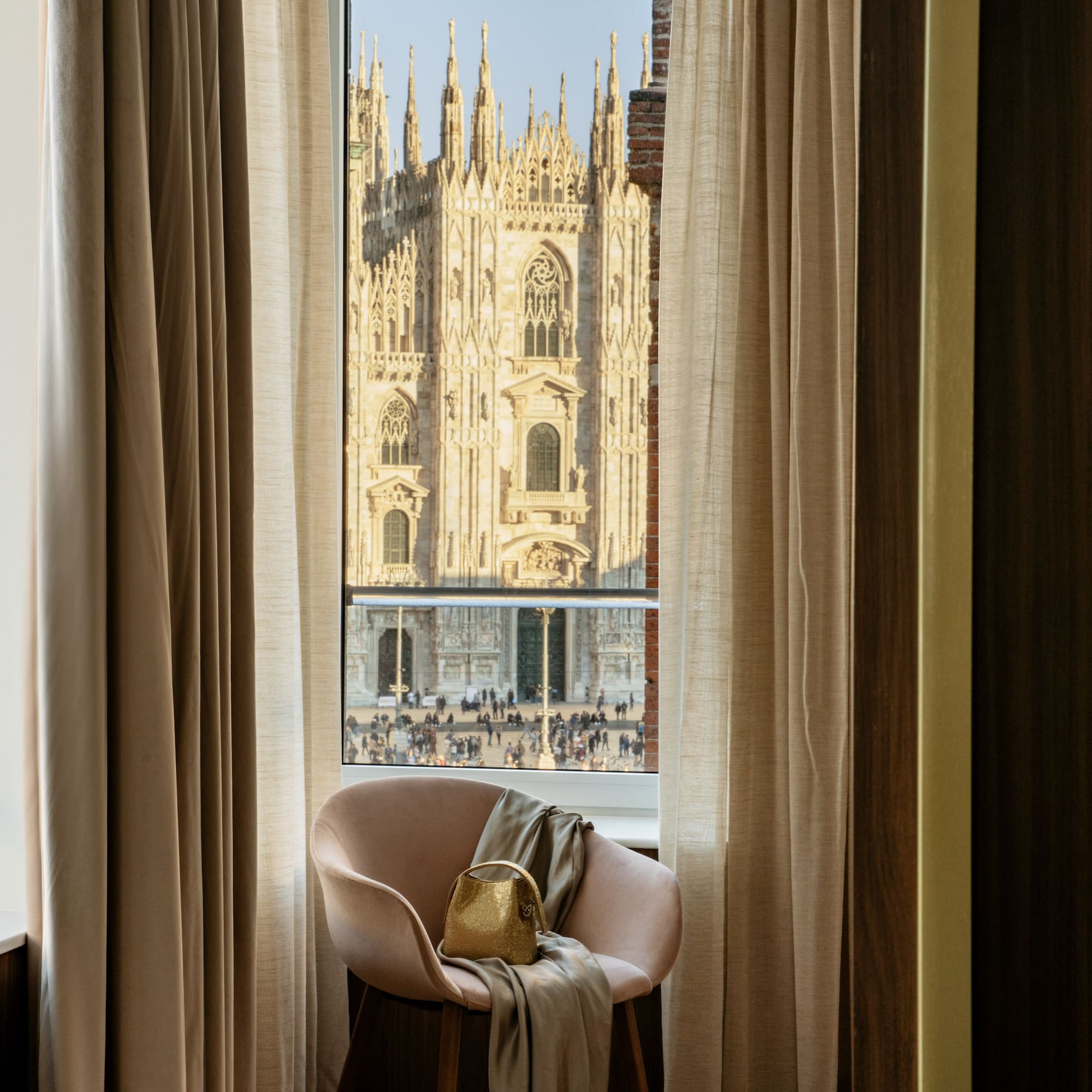 a chair in front of a window with a large building in the background