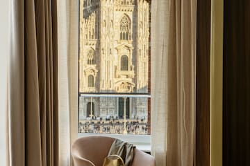 a chair in front of a window with a large building in the background