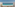 Hotel balcony with chairs, table, and stunning turquoise ocean view.
