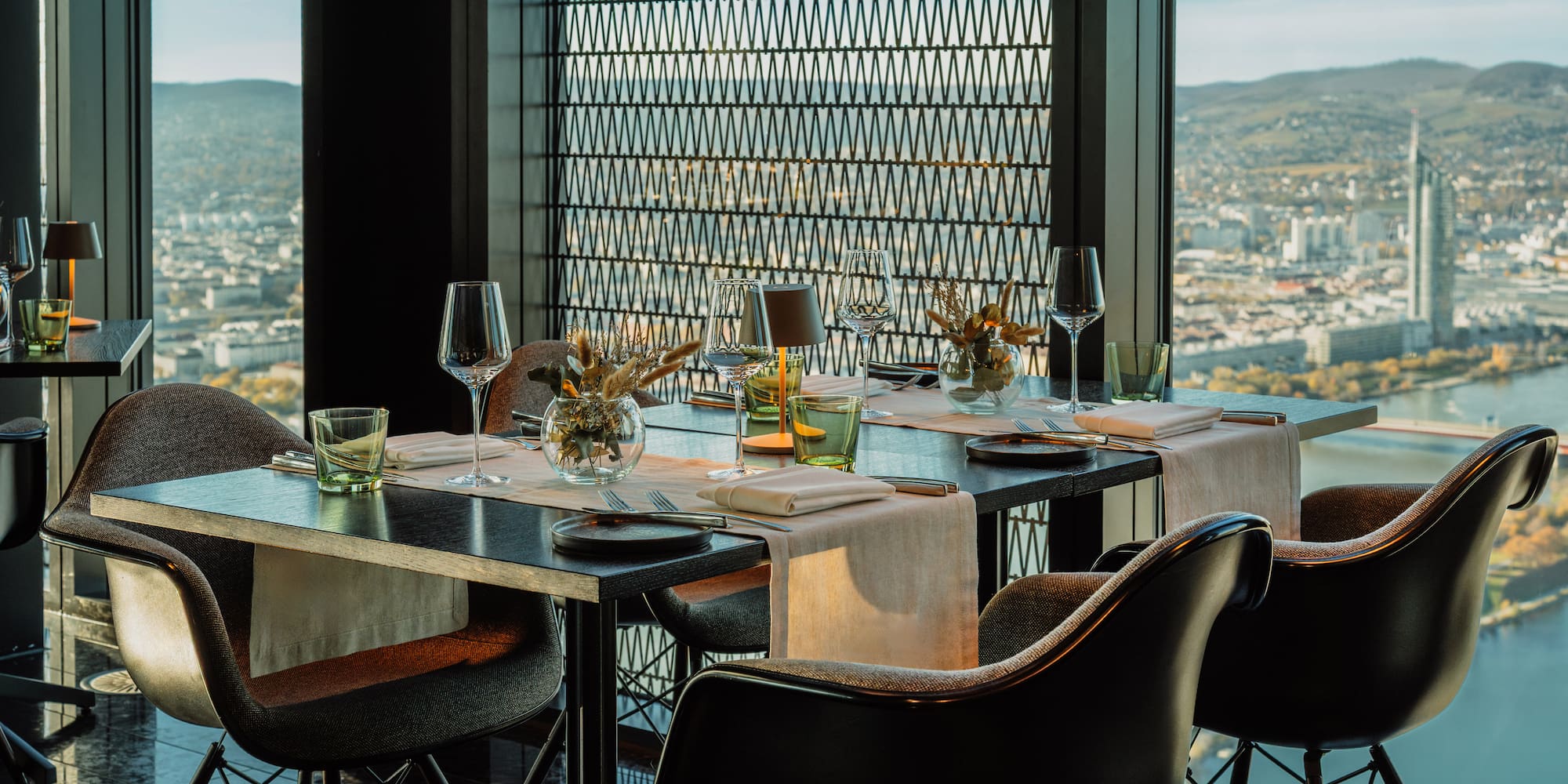 Modern restaurant in Vienna with panoramic city and Danube river view.