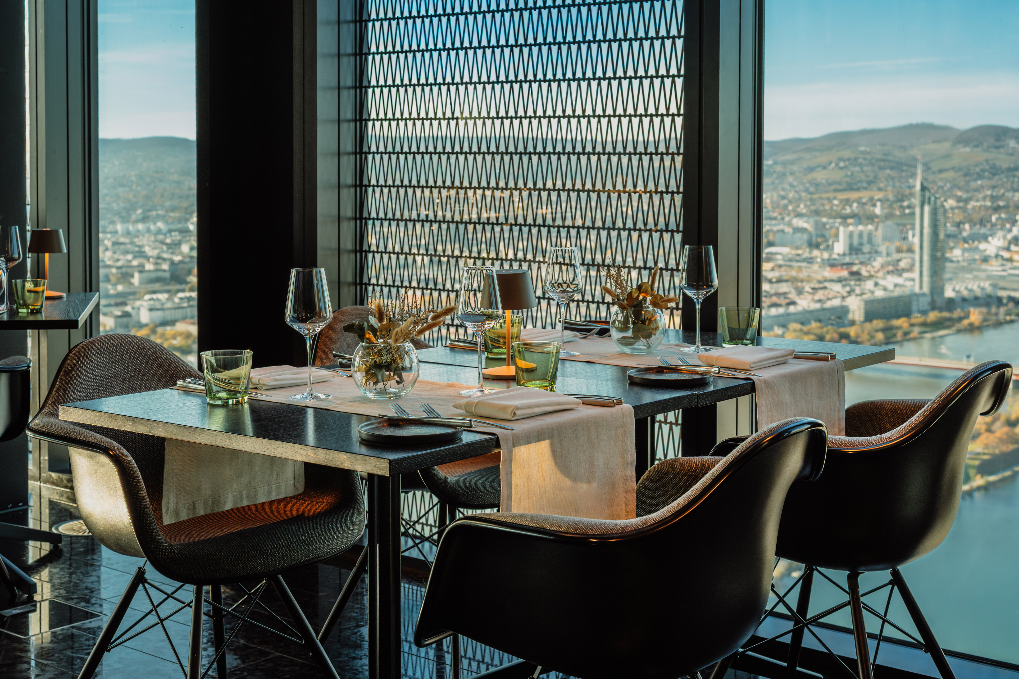 Modern restaurant in Vienna with panoramic city and Danube river view.