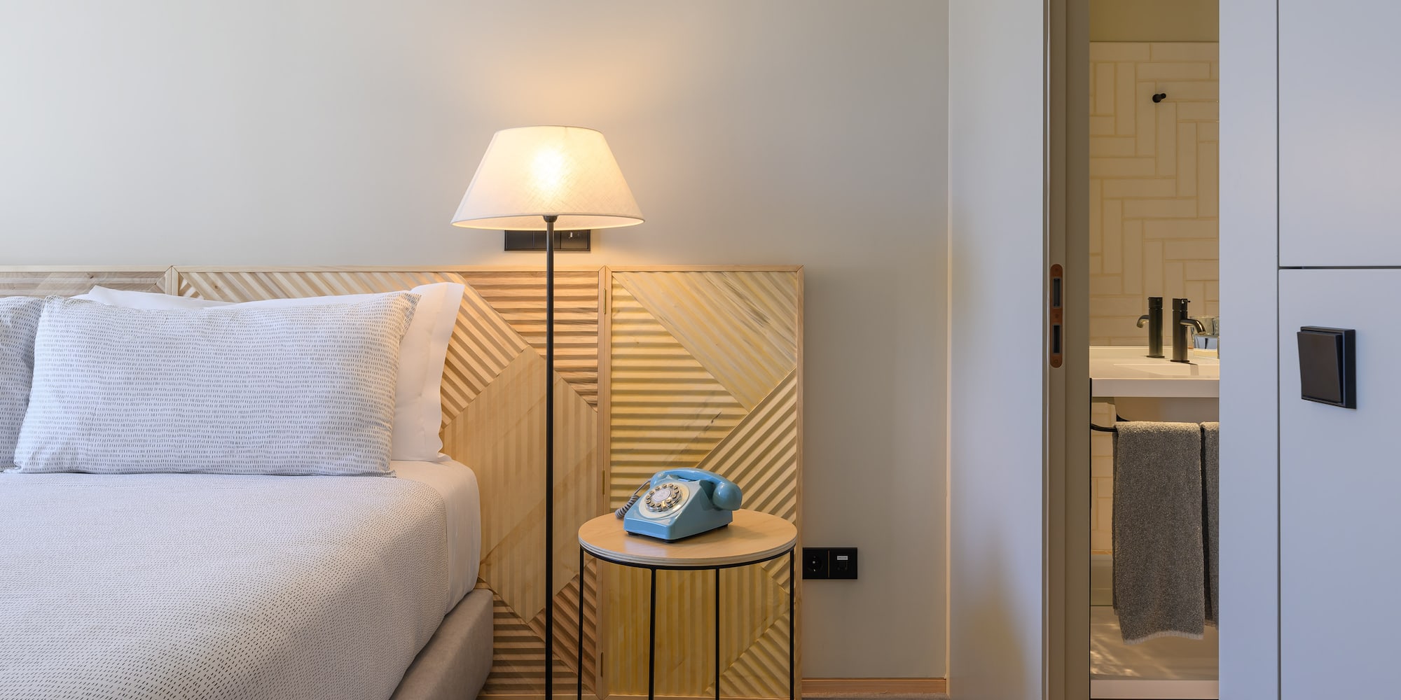 a bed with a telephone on the side of the bed