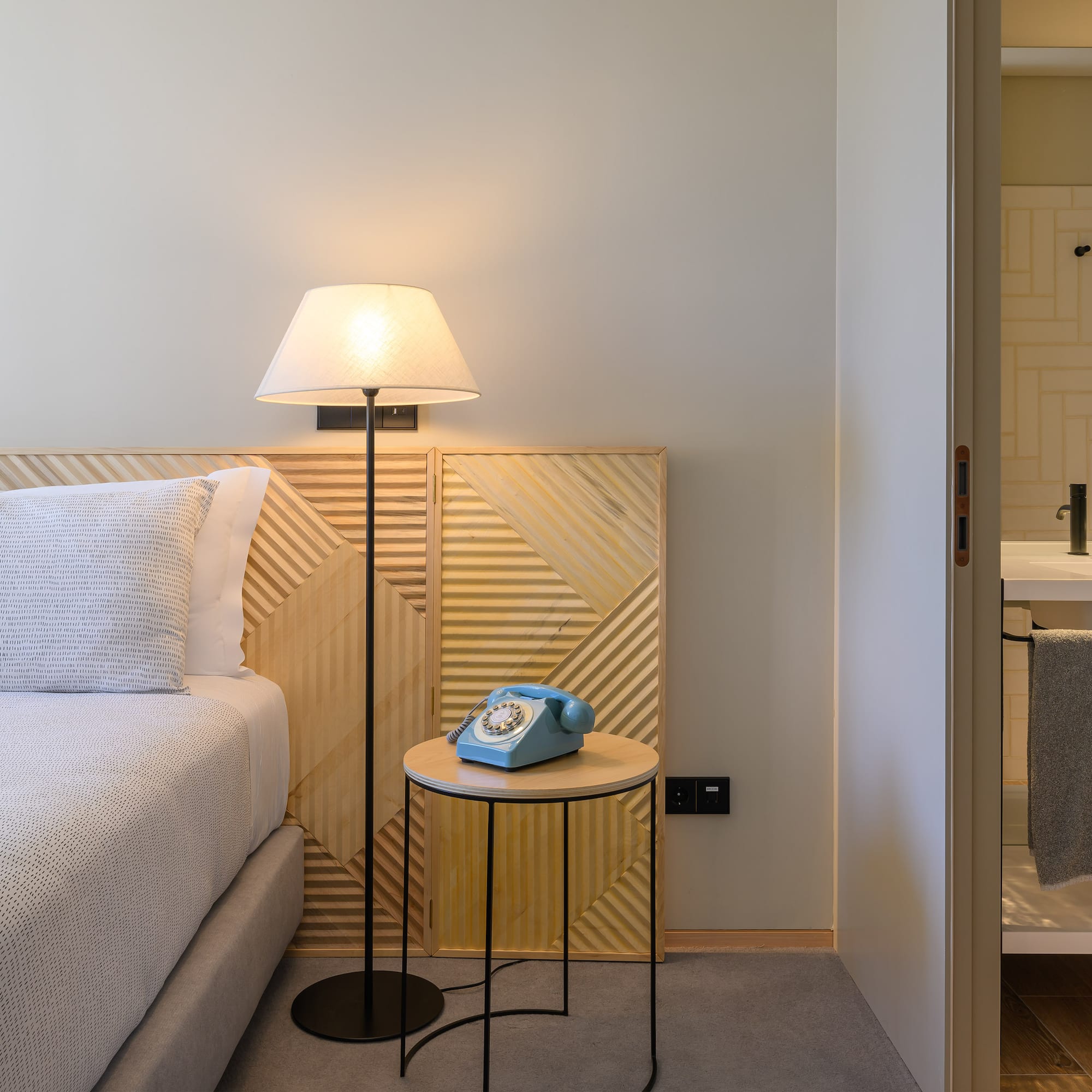 a bed with a telephone on the side of the bed