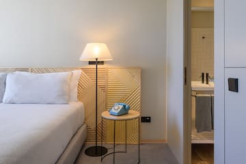 a bed with a telephone on the side of the bed