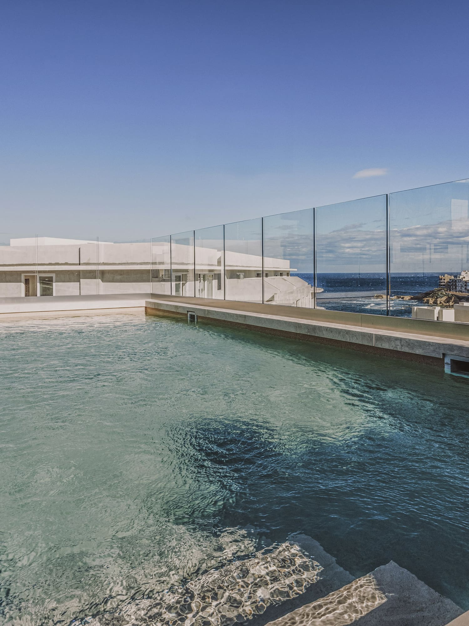 a pool with a glass fence