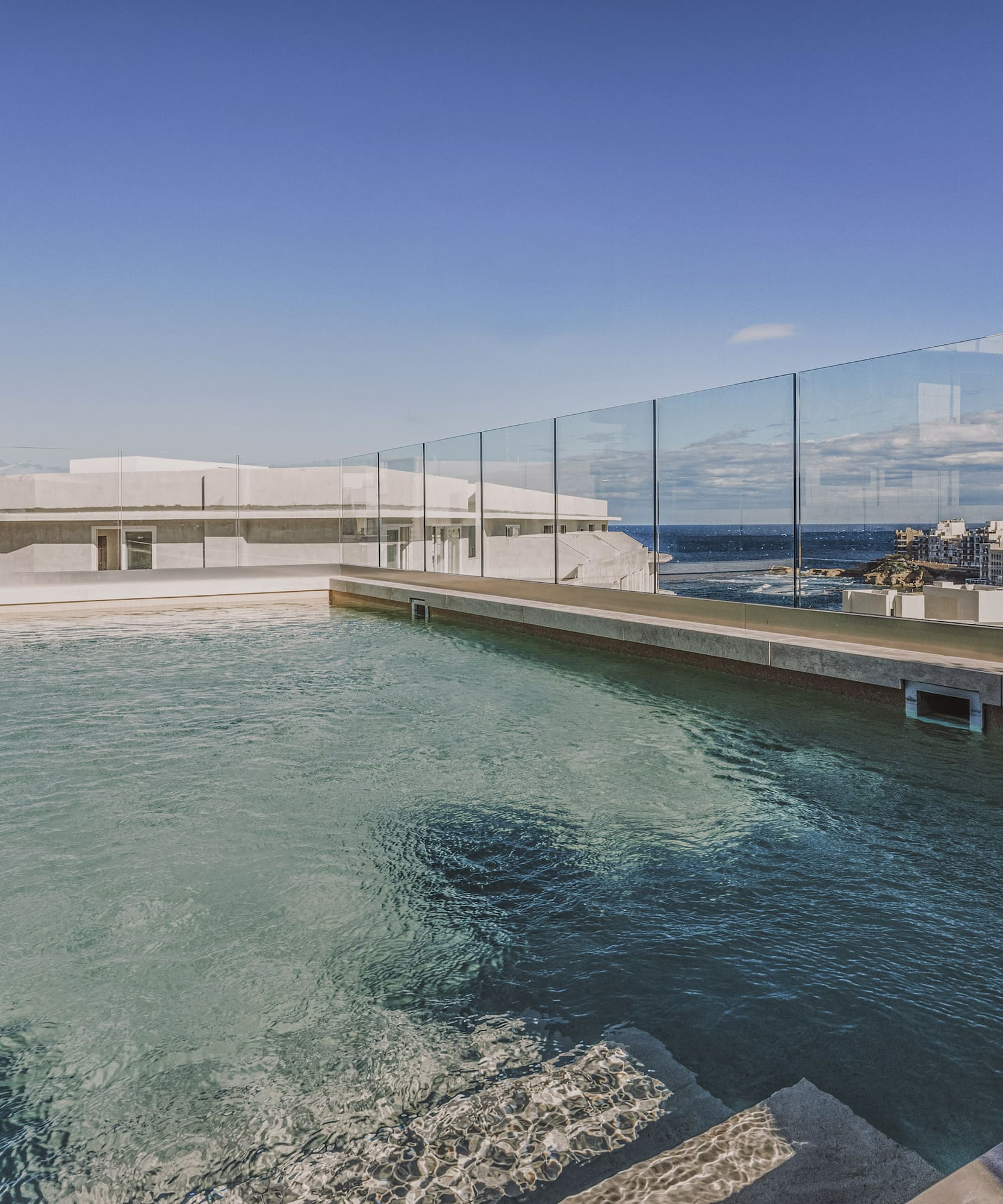 a pool with a glass fence