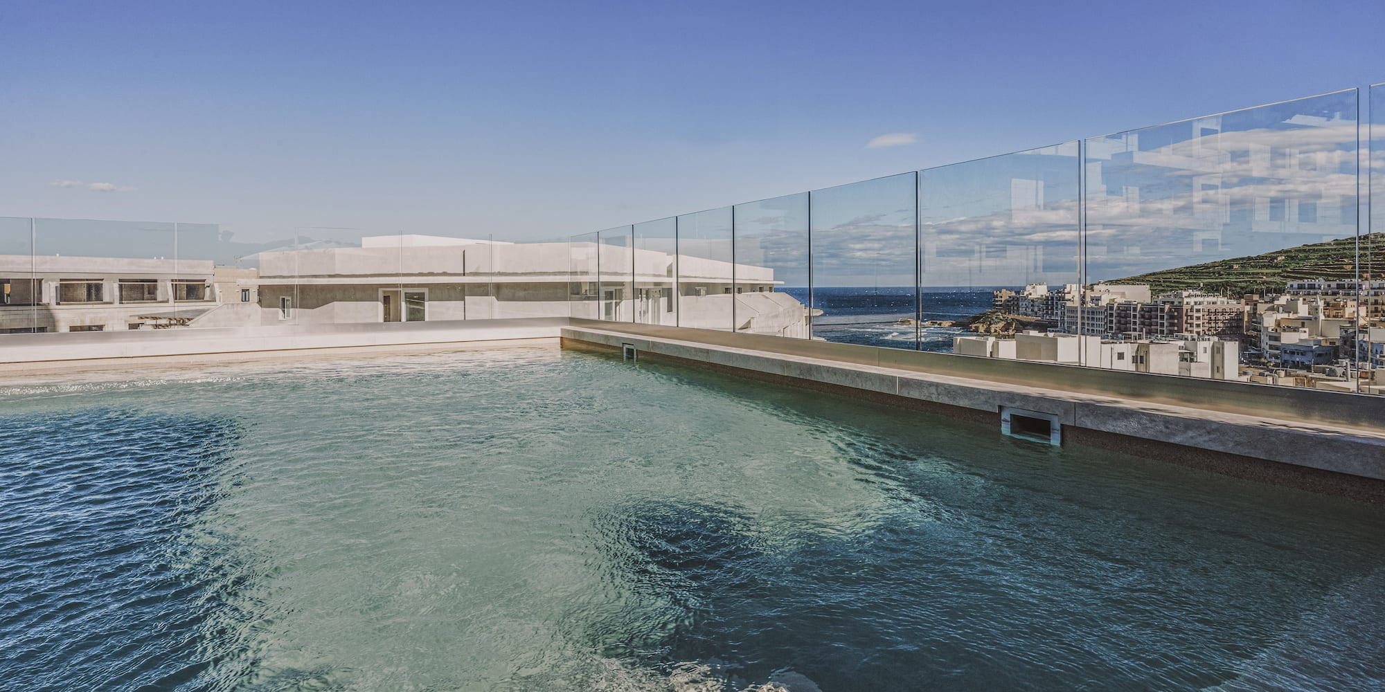 a pool with a glass fence