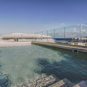 a pool with a glass fence