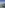 Rooftop infinity pool with glass barrier, ocean, and coastal town views.