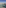 Rooftop infinity pool with glass barrier, ocean, and coastal town views.