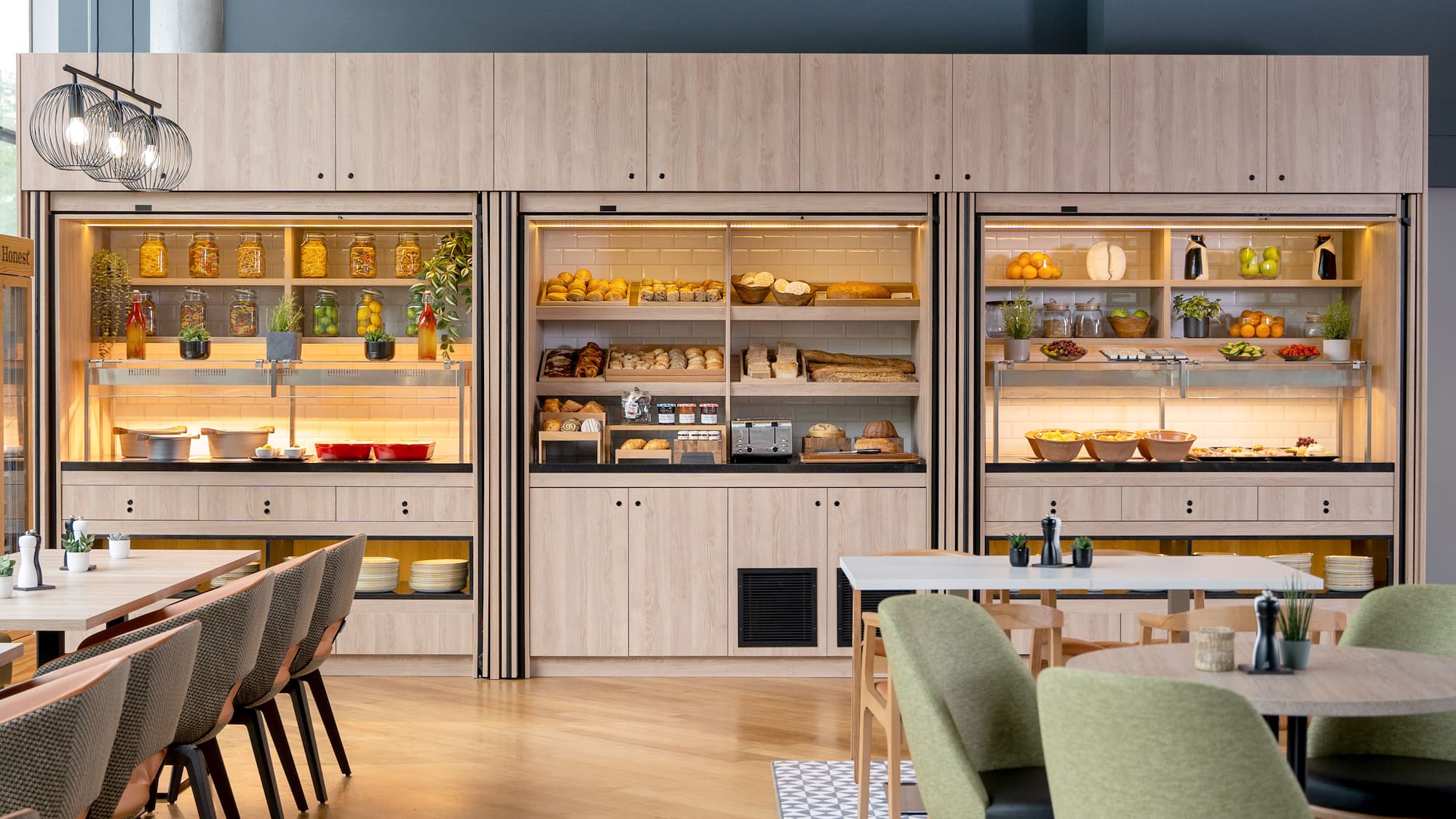 a room with a table and chairs and a display case